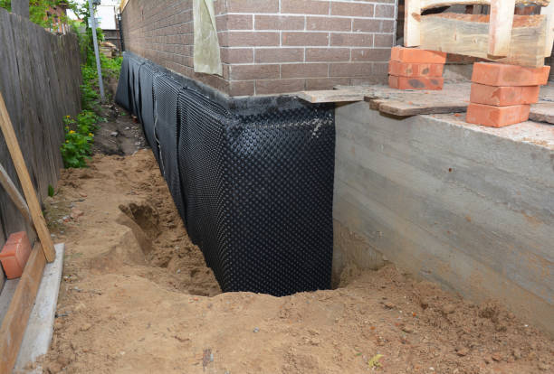 Happy homeowners after waterproofing job in Lacarne
